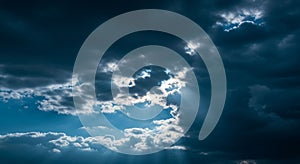 Dark clouds dominate the sky, creating a dramatic contrast with patches of light