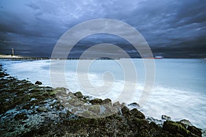 Dark clouds drift over the Dutch coastline with stormy weather.