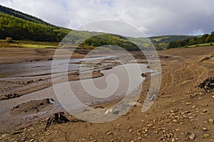 Dark clouds gather over a dried up Ladybower reservoir