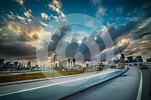 Dark clouds over a highway in Miami at sunset