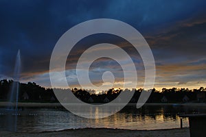 Dark clouds over the lake of Landgoed `t Loo awaiting of a thunderstorm and rain.