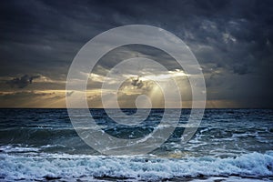 Dark clouds over stormy sea hiding sunlight in Thailand