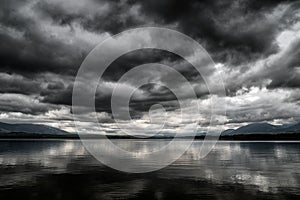 Dark clouds on the sky over lake