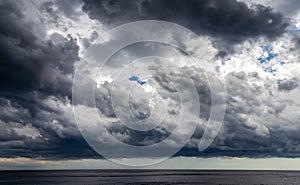 Dark clouds of storm over sea surface