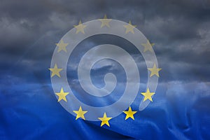 Dark clouds viewed through EU flag