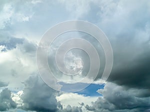 Dark cloudscape light blue sky background