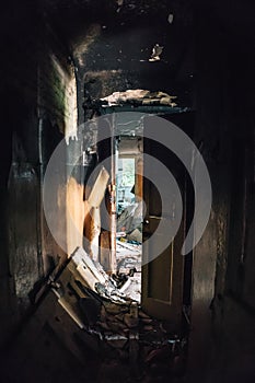 Dark corridor in burned ruined house building after disaster, war, earthquake, Hurricane or other natural cataclysm