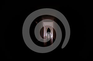 Dark corridor with cabinet doors and lights with silhouette of spooky horror man standing with different poses.