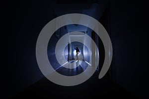 Dark corridor with cabinet doors and lights with silhouette of spooky horror man standing with different poses.