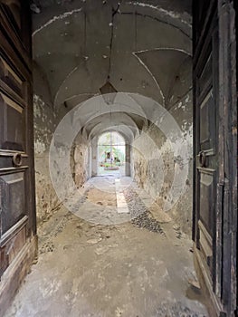 Dark corridor in the old town with the wooden doors.