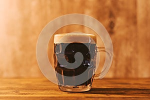 Dark craft beer in british dimpled glass pint mug