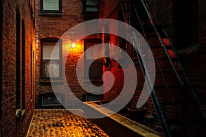 A dark creepy narrow boston alley at night