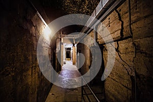 Dark creepy old corridor of underground bunker or prison