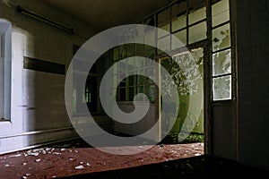 Dark and creepy room of old abandoned mental hospital at night