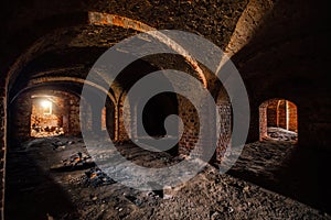 Dark and creepy vaulted red brick dungeon