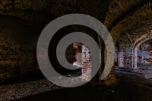 Dark and creepy vaulted red brick dungeon