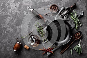 Dark culinary background with empty black pan