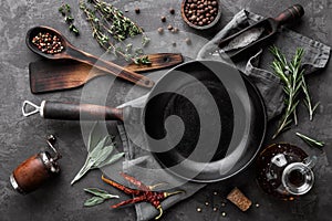 Dark culinary background with empty black pan