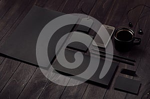 Dark deluxe black branding stationery, mockup scene with phone, coffee on black wooden plank.