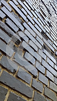 Dark dirty bricks. Old dark brick wall. Vintage background