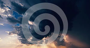 dark dramatic clouds in cloudy sky in a storm and rain at sunset