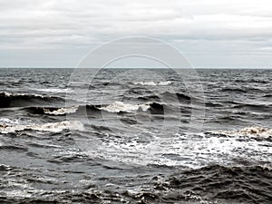 Dark dramatic seascape with breaking waves in stormy weather