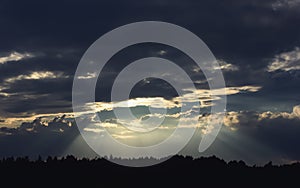 Dark Dramatic Sky with Sunbeams Through Storm Clouds