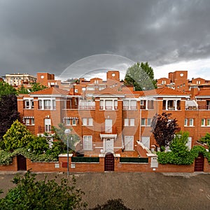 Dark and dramatic storm skies loom over the townhouses in central Spain.