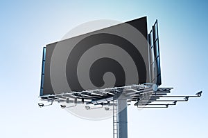 Dark empty billboard on a steel structure with a clear sky background, ideal for large scale mockups.