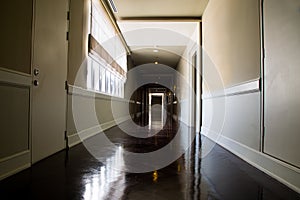 Dark and empty corridor with available natural light from window