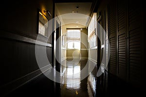 Dark and empty corridor with available natural light from window