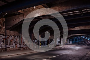 Dark empty dirty grunge underground concrete tunel with a road during mystic night with blue street photo