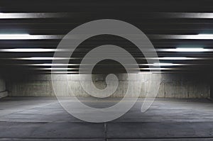 The dark empty parking garage at night