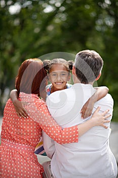 Dark-eyed African-American girl meeting her adoptive parents