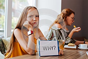 Dark-eyed teenage girl feeling brokenhearted waiting for mother