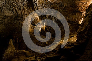 Dark and fantastic cave with stalagtite and stalagmite