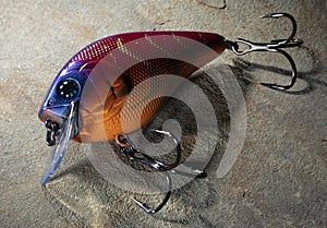 Dark fishing lure on a rock photo