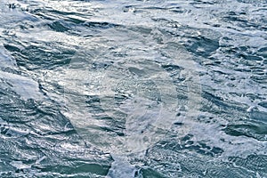 Dark foaming waves of stormy sea, background