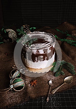 Dark food photo of glazed christmas chocolate cake with christmas decorations and balls - rustic and vintage style