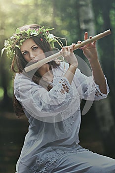 Dark forest nymph with a flute photo