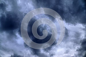 Dark forming clouds with blue sky elements right before a thunderstorm