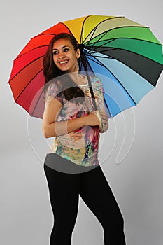 The dark girl under a beach umbrella