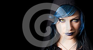 Dark girl with yellow cats eyes, blue hair and black hood