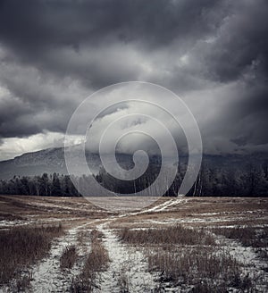 Dark Gloomy Landscape with Country Road in Snow