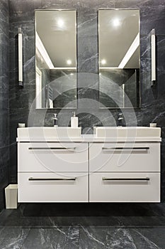 Dark granite bathroom with cabinet