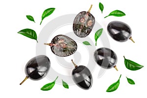 Dark grapes decorated with green leaves isolated on white background, top view. Flat lay