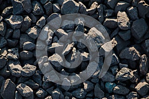 Dark gravel pebbles stone texture.