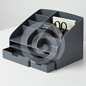 A dark gray plastic desk organizer featuring multiple compartments for storing office