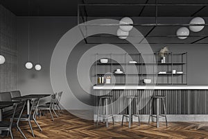 Dark gray pub interior with bar counter and tables