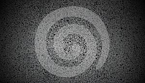 Dark gray speckled textured background with vignetting